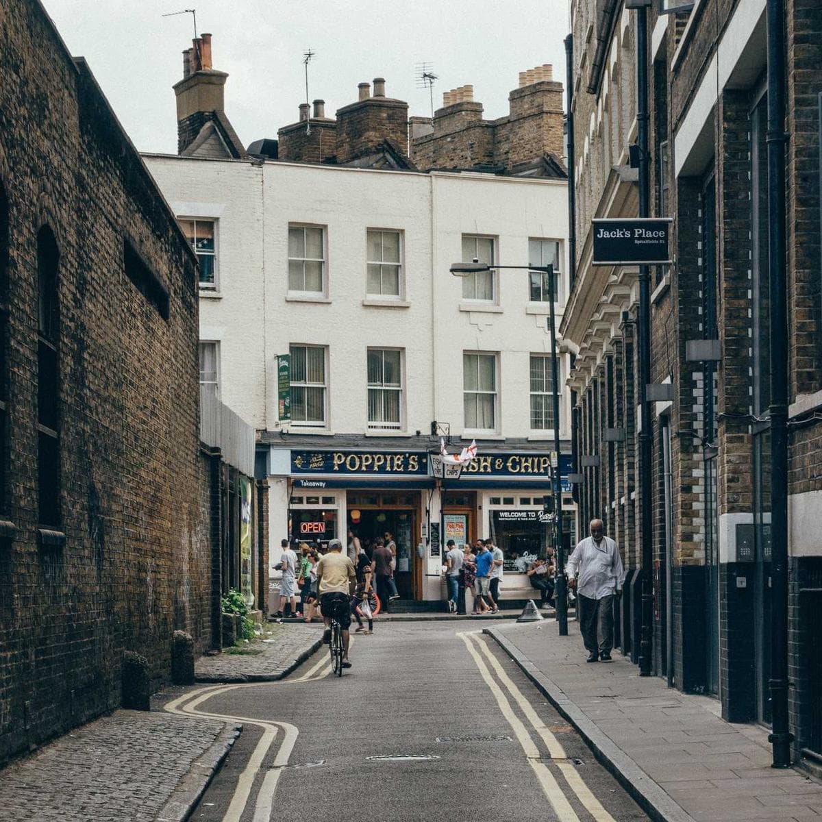 A quiet Soho side street with a chippy at the end